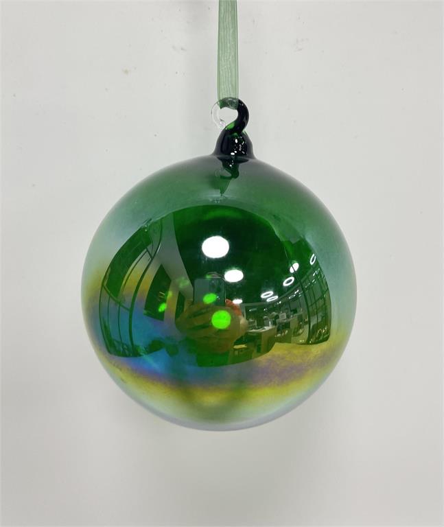 A 100mm green iridescent glass ball ornament hanging from a thin green ribbon.