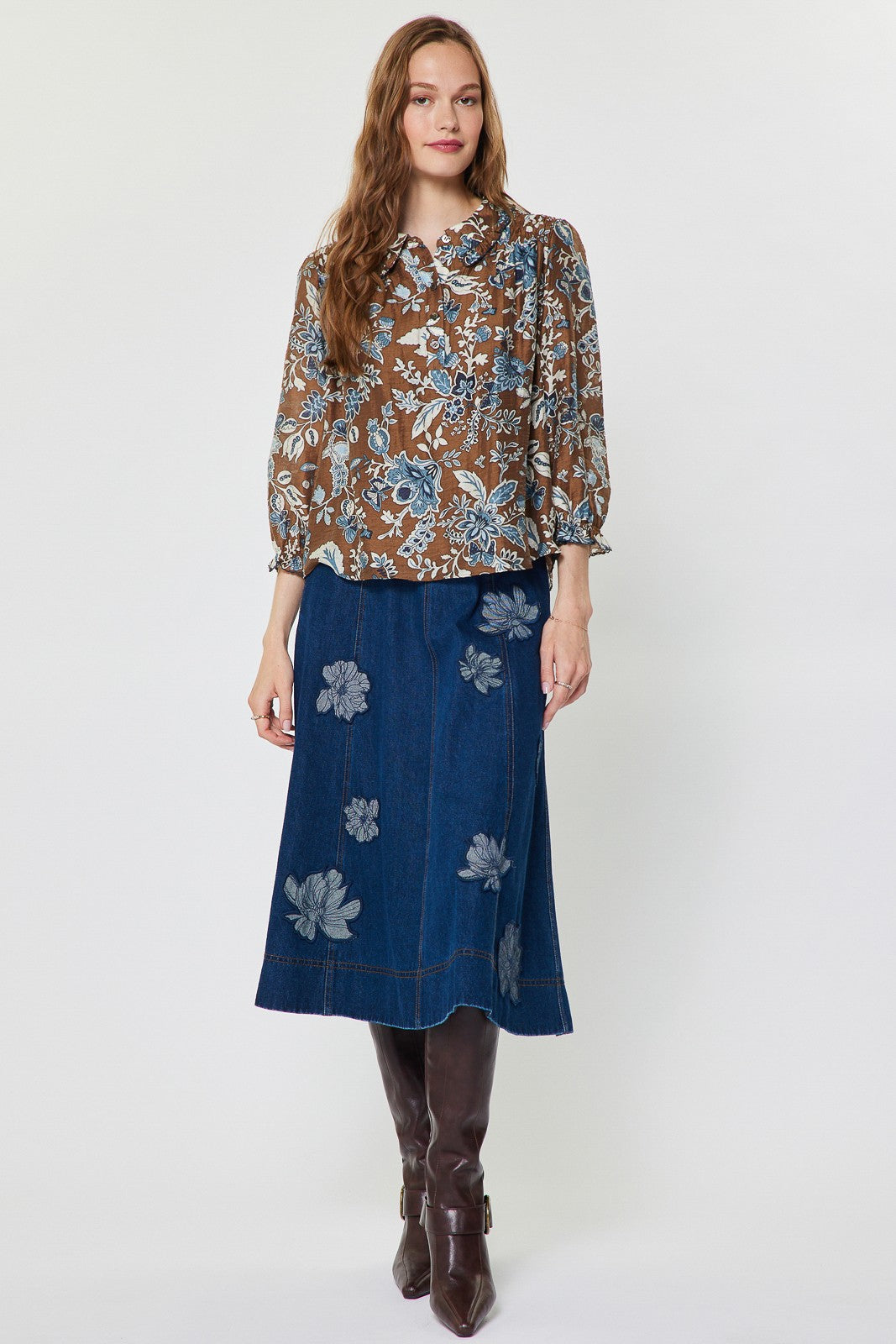 Sheer floral paisley blouse with shirt collar, ruffled detail, half placket buttons, and smocked back in Tencel blend.