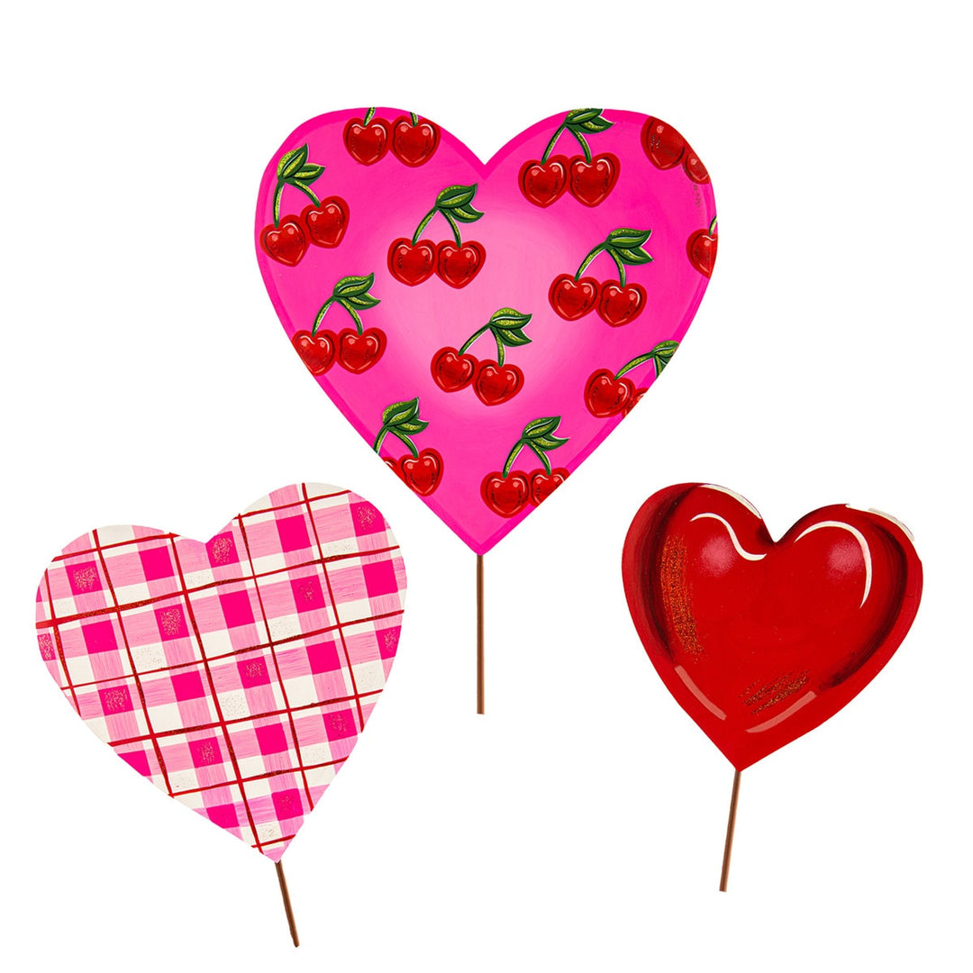 Metal garden stake with a pink cherry heart top in red, white, and plaid colors.