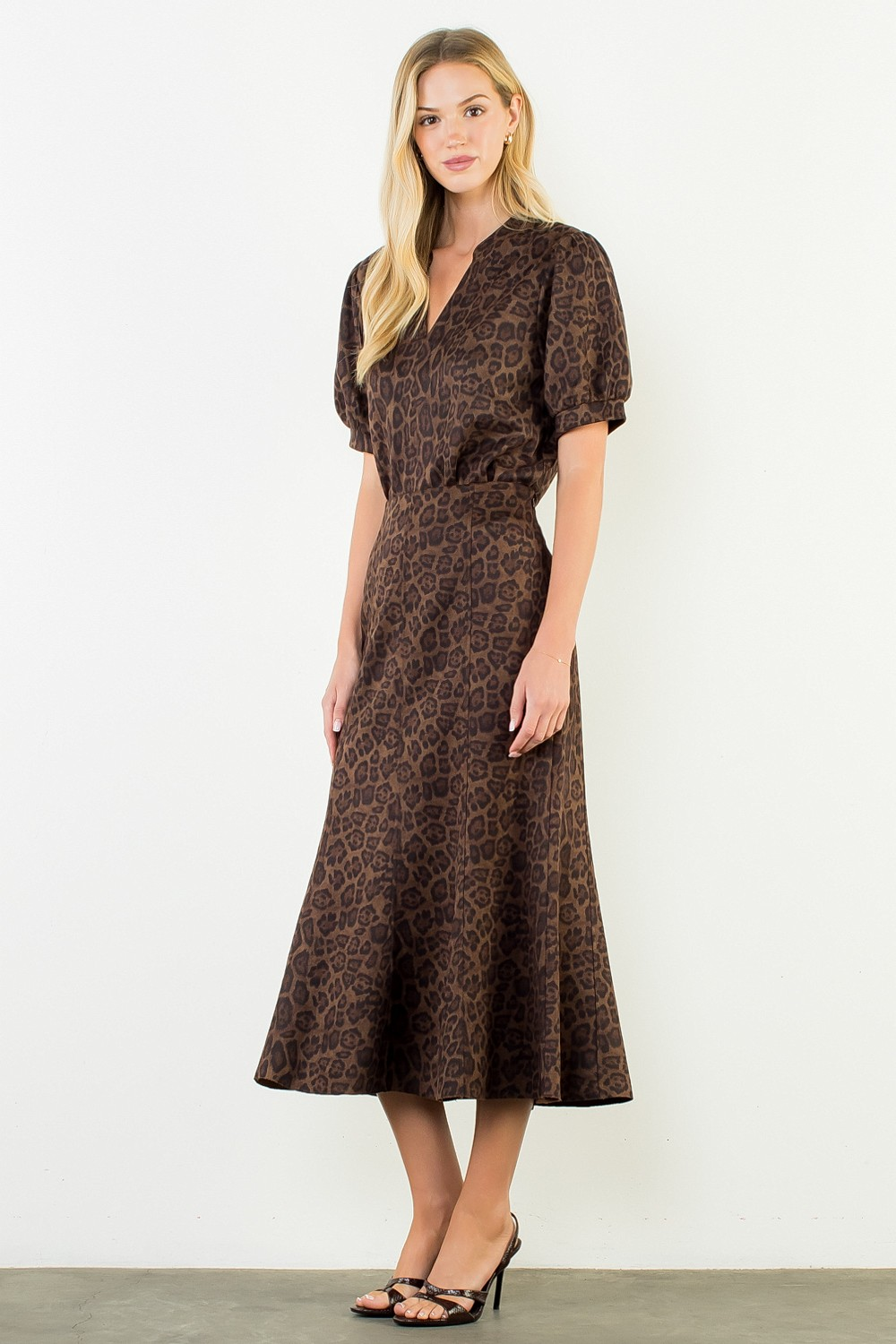 Woman wearing the Stella Suede Animal Print Top with a matching midi skirt.