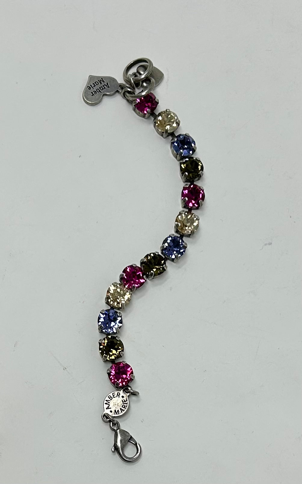 Milan bracelet featuring multi-colored crystal stones in a silver setting with Amber Marie charms.