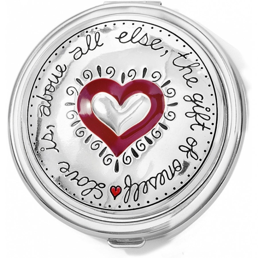 Silver-plated compact mirror with red accents, clasp closure, and side magnification.