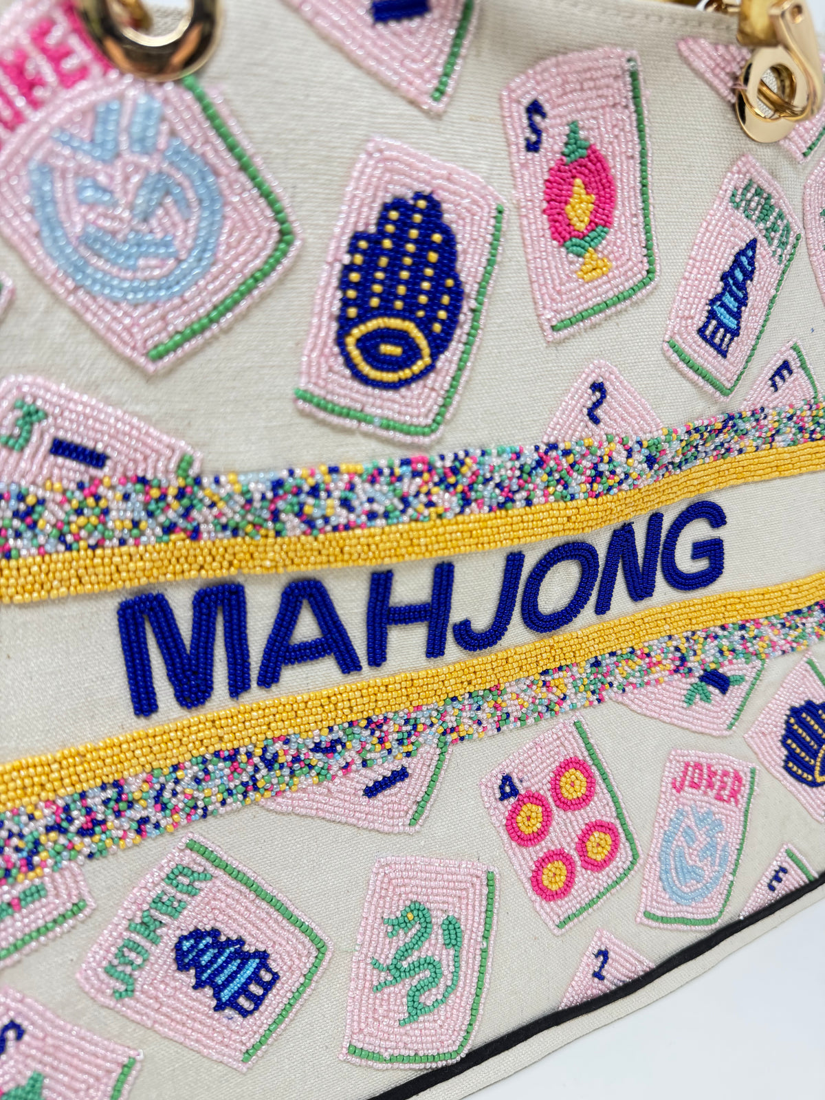 Close-up of a hand-beaded tote bag featuring pink mahjong tiles and blue beaded 'MAHJONG' text.