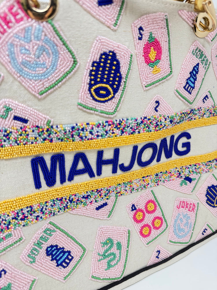 Close-up of a hand-beaded tote bag featuring pink mahjong tiles and blue beaded 'MAHJONG' text.