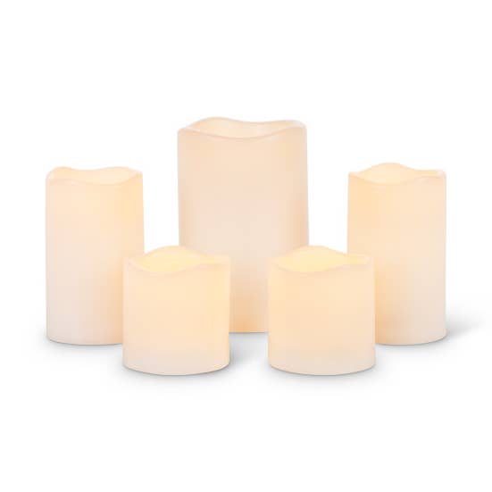 Set of five bisque resin LED candles in varying heights with a flickering warm glow.