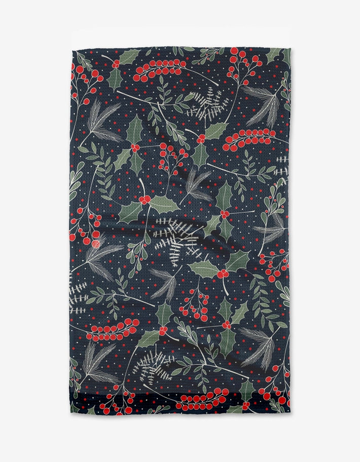 Holiday-themed tea towel with waffle weave construction in red featuring festive snowflake pattern and hang loop.