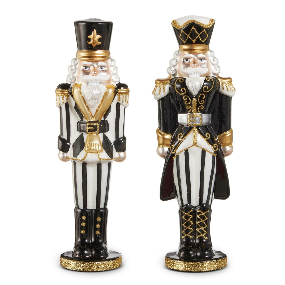Two 10.5-inch glass nutcrackers in black and white with gold glitter accents and striped patterns.