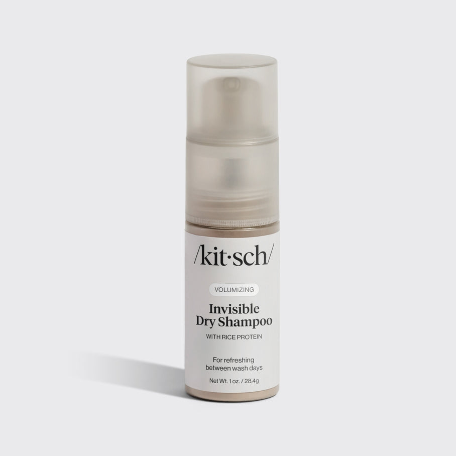 Volumizing Rice Protein dry shampoo pump bottle in light-tinted powder with compact travel design