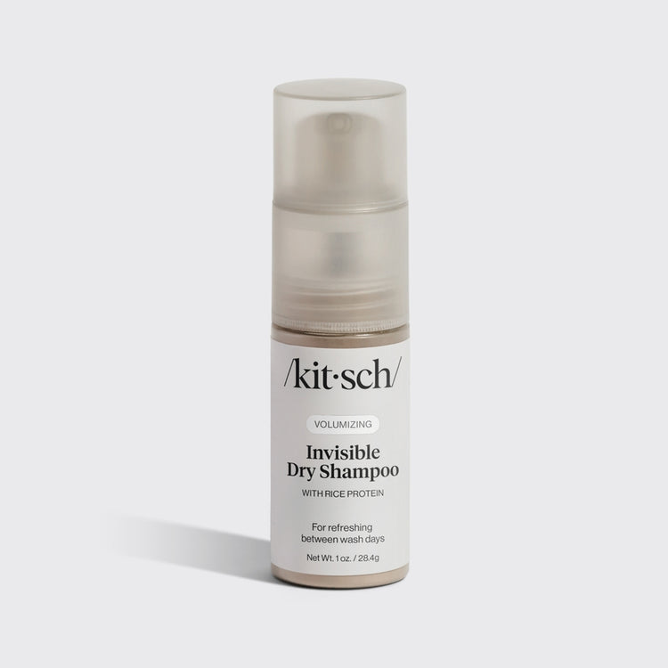Volumizing Rice Protein dry shampoo pump bottle in light-tinted powder with compact travel design