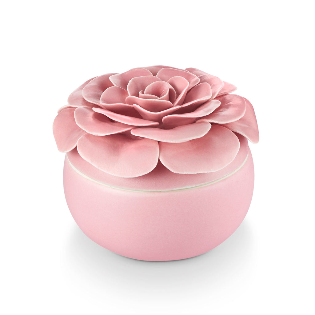 Ceramic flower candle with three wicks in a petal-shaped vessel filled with plant-based wax.