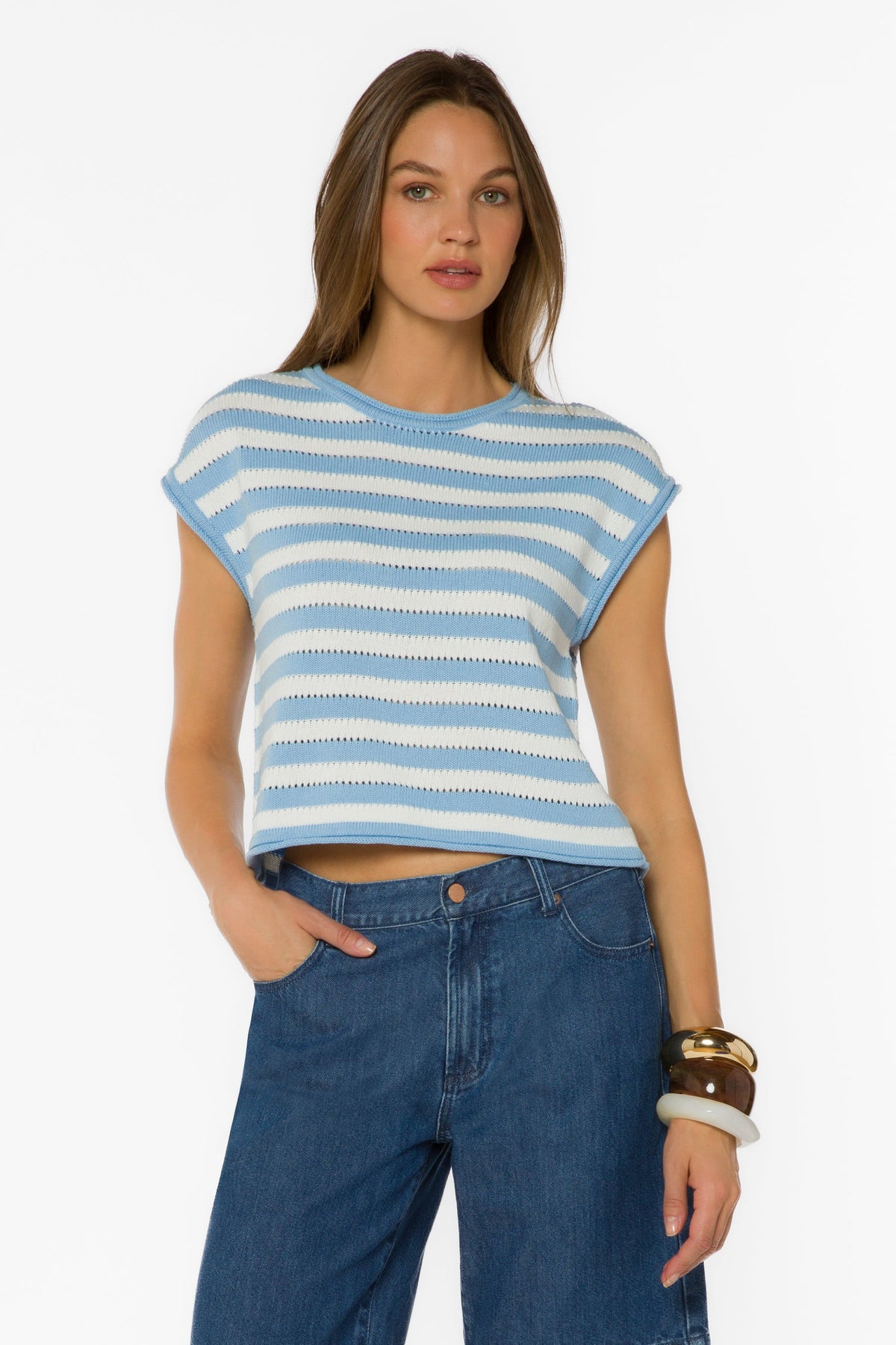 Woman wearing the Abree Optic White Stripe Sweater, a blue and white knit top with short sleeves.