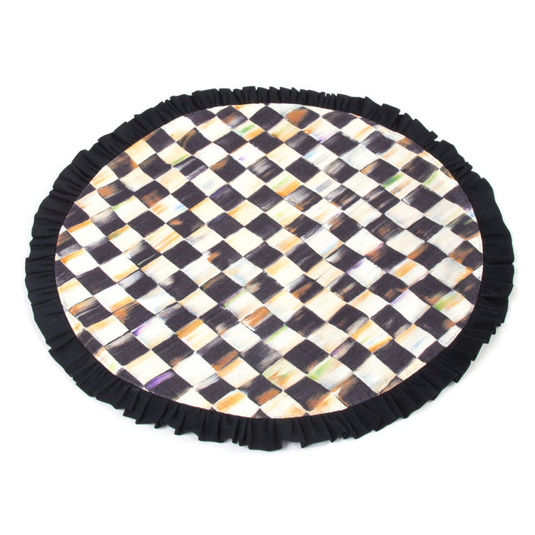 Courtly Check round cotton placemat with a hand-painted black and white pattern and ruffled trim.