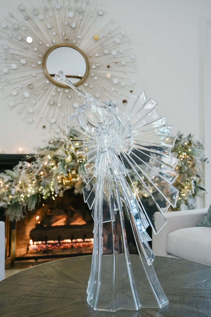 Large 34-inch clear acrylic angel figurine with detachable wings and trumpet on a table.