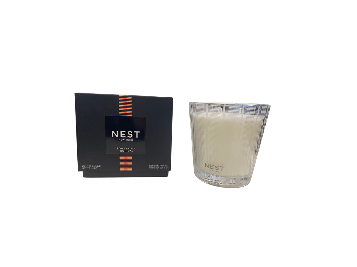 Nest 3-Wick candle in a clear glass jar with white wax.