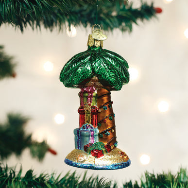 Christmas palm tree ornament with green fronds on a gold stem.