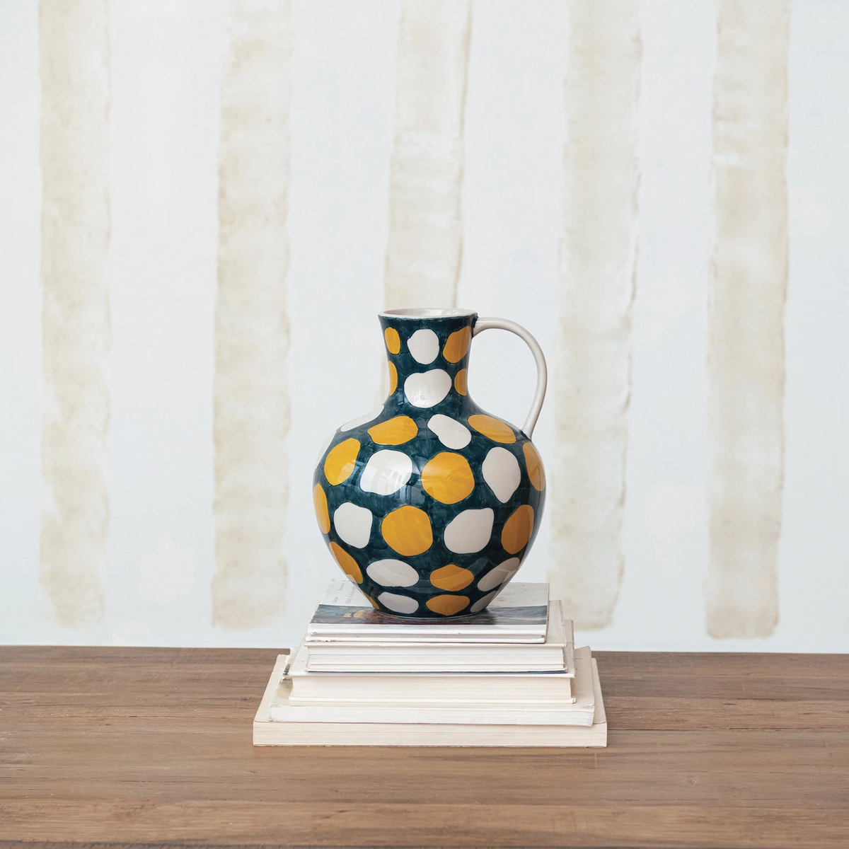 Round stoneware jug with wax relief dot patterns in earth tones