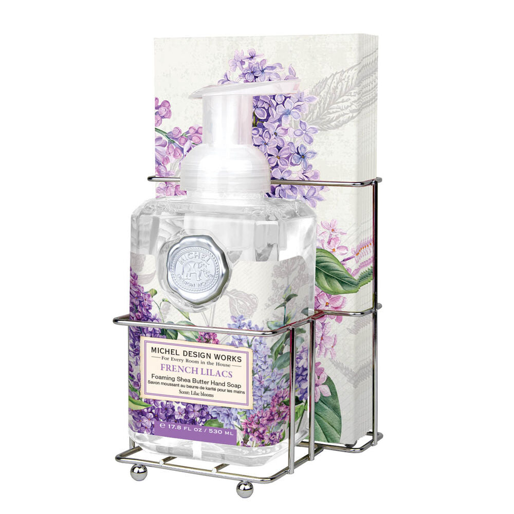 Compact foaming hand soap dispenser with matching napkin holder in a neutral finish.
