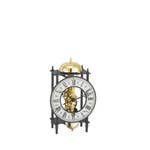 German table clock with a rectangular wooden frame, white face, black hands, and Roman numerals.