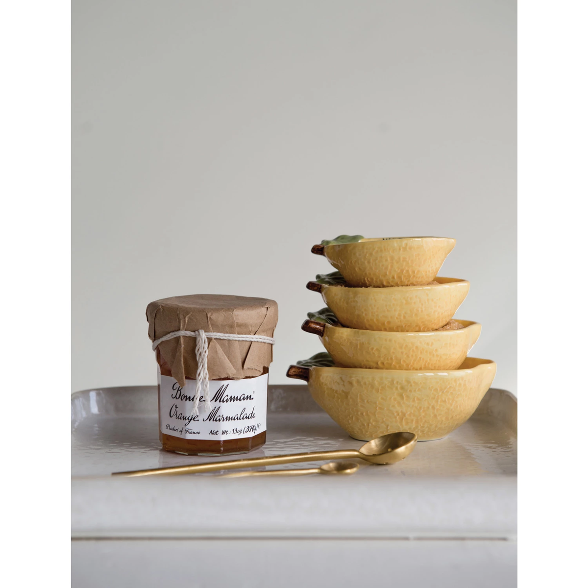 Set of stoneware lemon-shaped measuring cups with a matte finish.