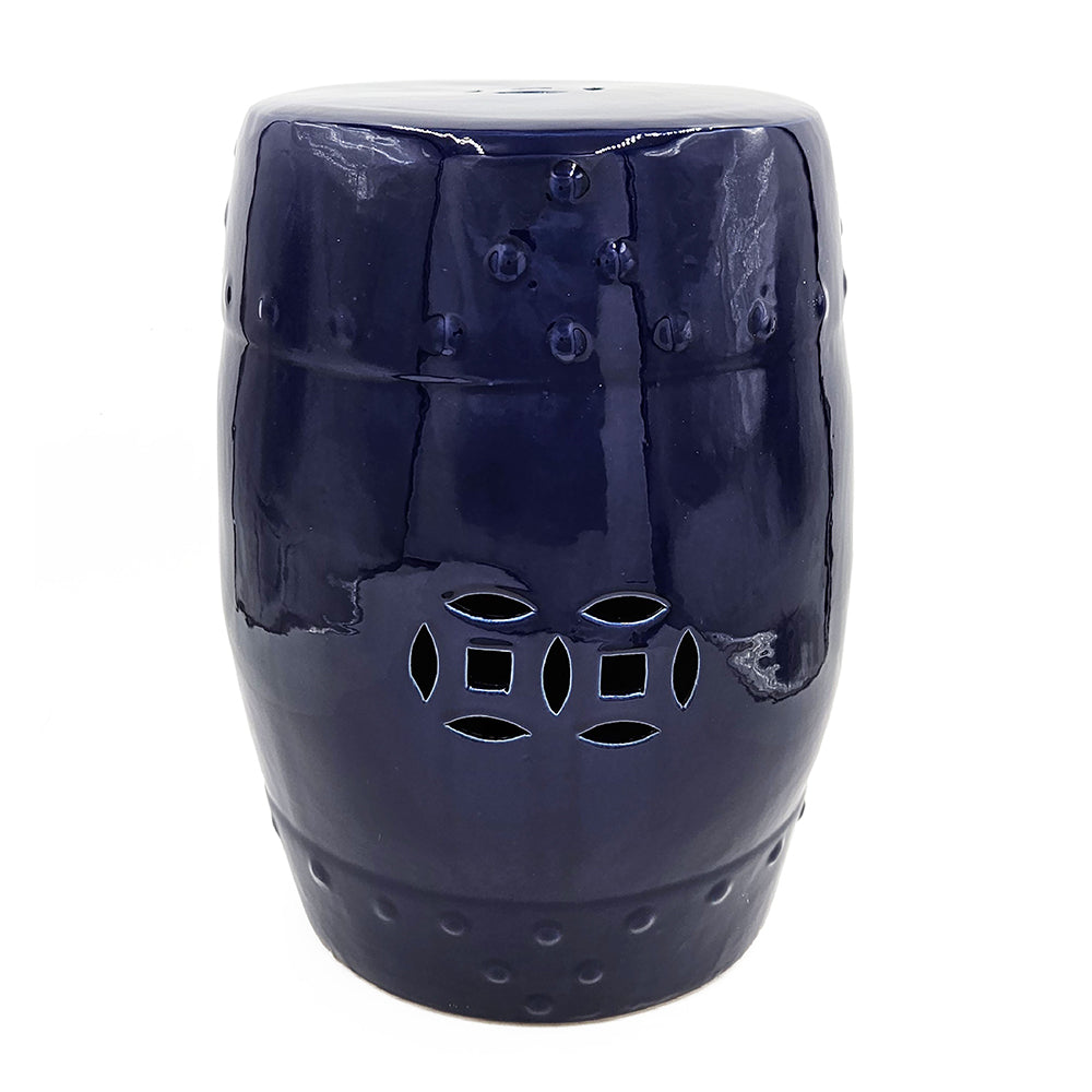 Ceramic barrel stool with cobalt blue cutout geometric design on white background