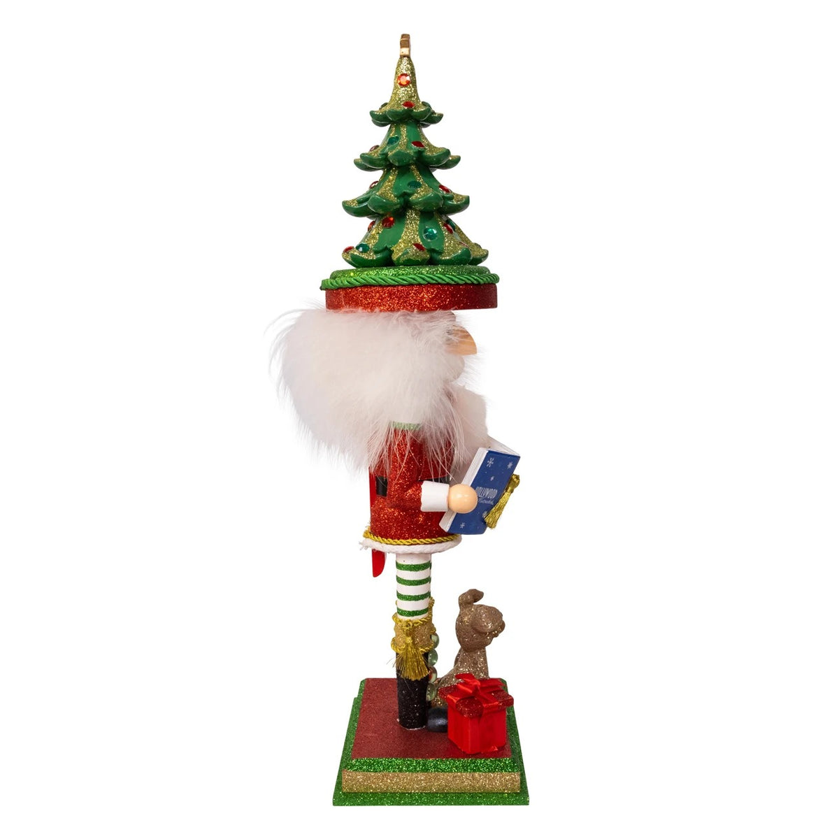 18-inch Hollywood Nutcracker with a Christmas tree hat, holding a book next to a dog and gift.