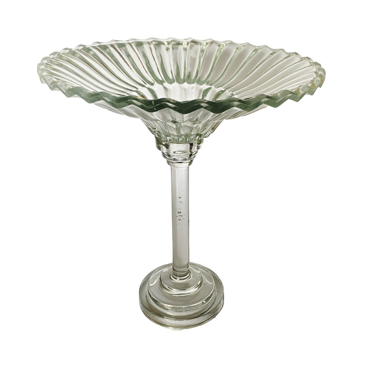Clear pressed glass pedestal bowl with a fluted, scalloped rim and a tall, slender stem.