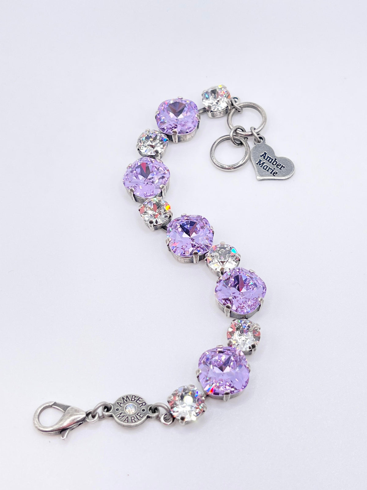 Premier Paris bracelet featuring alternating lavender and clear crystals with Amber Marie charms.