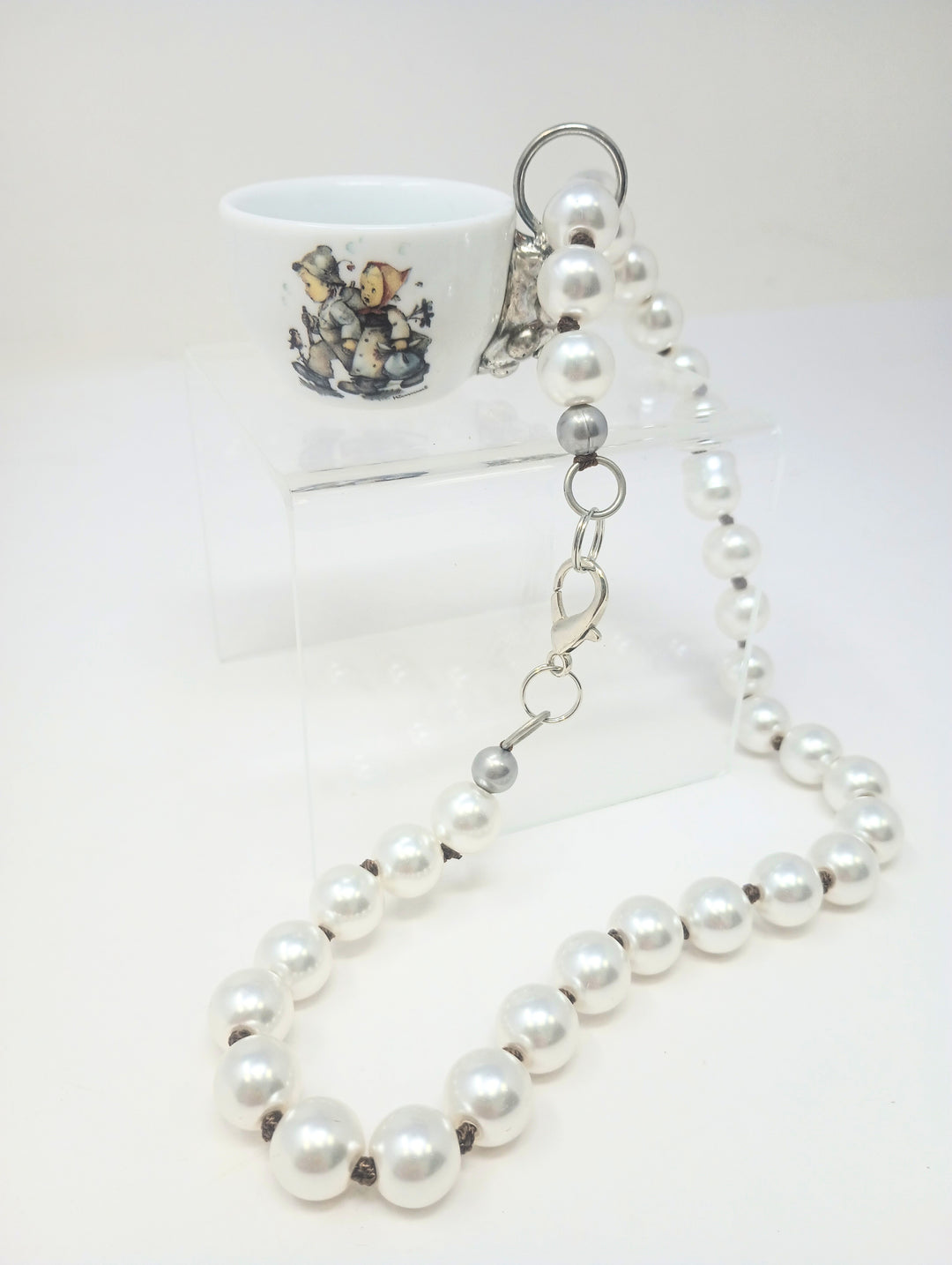 Pearl necklace with porcelain teapot charm featuring M.I. Hummel artwork