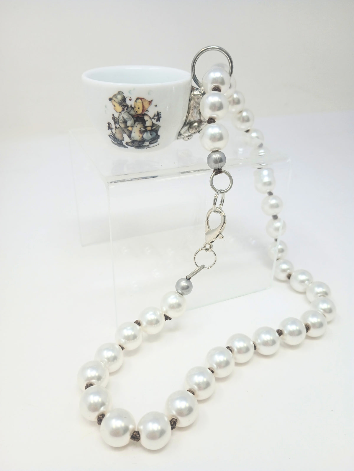 Pearl necklace with porcelain teapot charm featuring M.I. Hummel artwork
