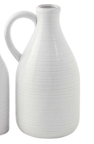 Clear glass milk jug vase with a narrow neck and wide cylindrical body.