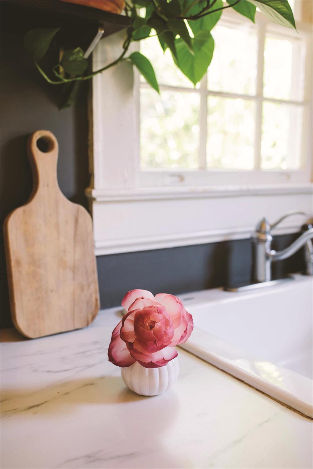Sweet Grace flower diffuser bottle with pink blooming silk flower stem inside clear glass vase.