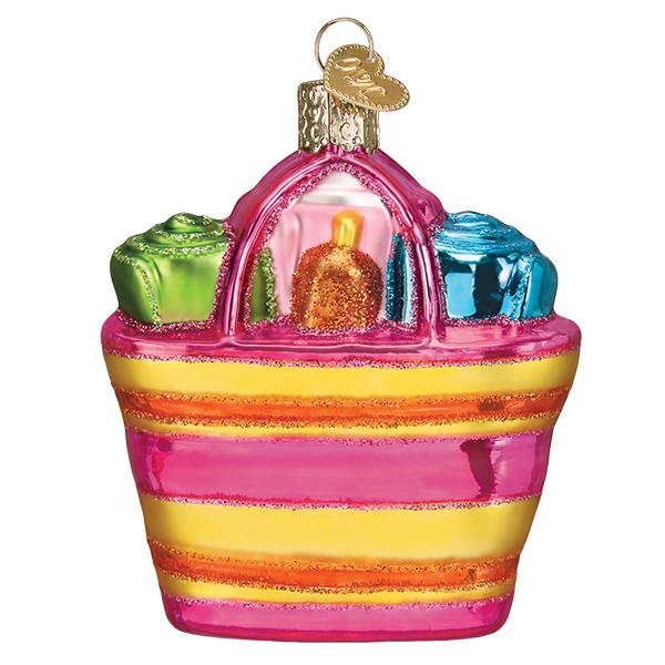 Glass beach bag ornament with pink and yellow stripes, containing a green towel and blue towel.