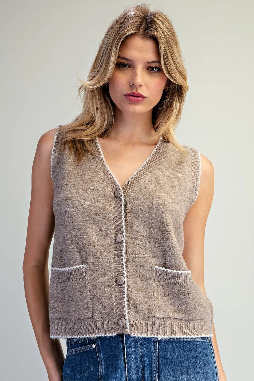Celeste taupe knit vest with white whipstitch trim, V-neck, button front, and two patch pockets.