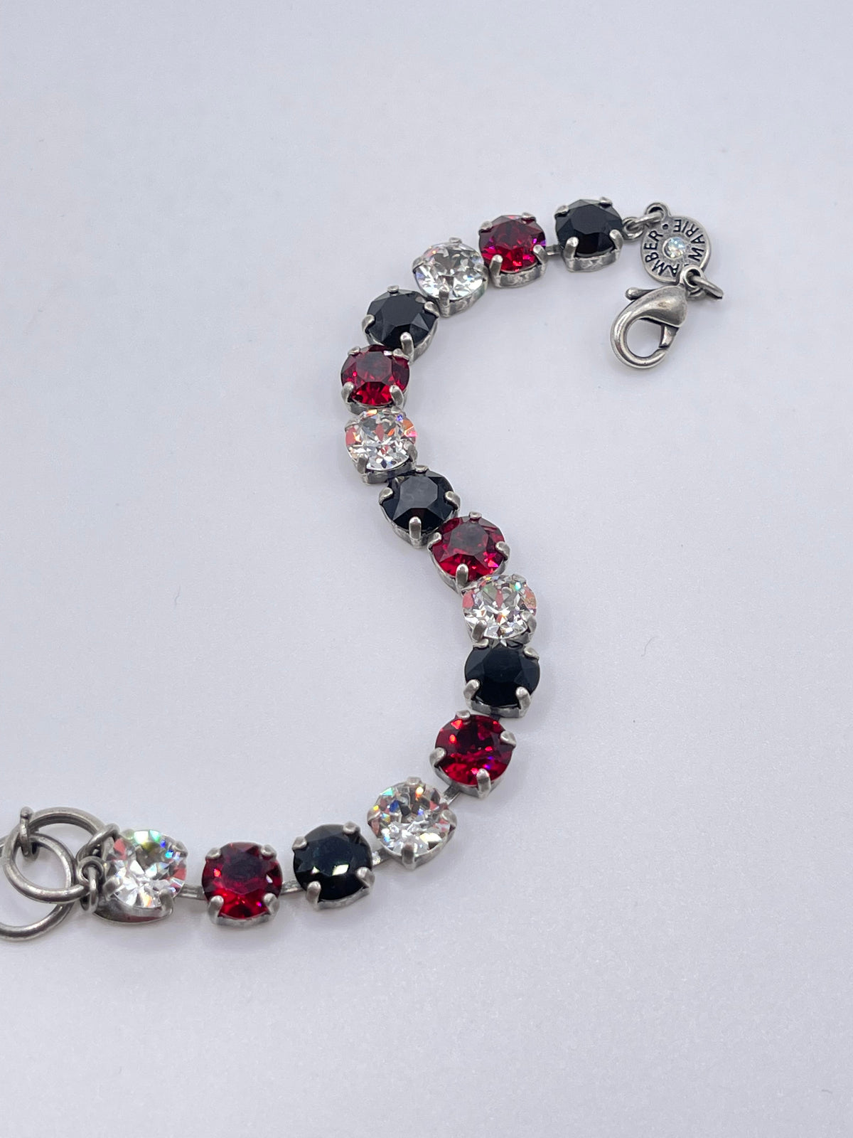 Classic Rome bracelet featuring deep red stones with black accents in a sleek metallic band.