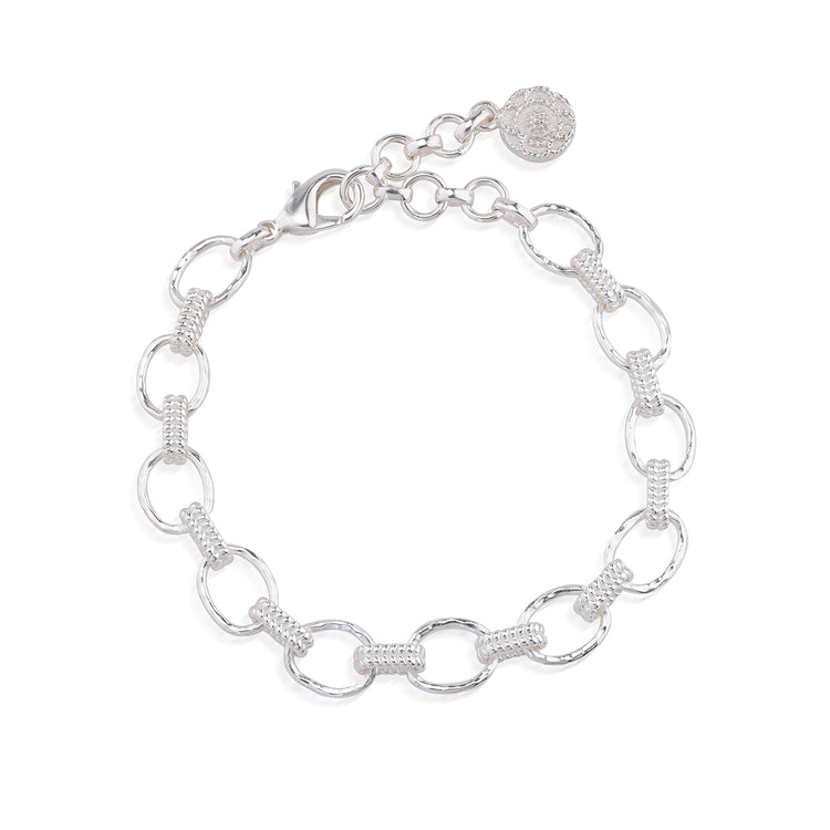 Silver Cleopatra bracelet with hammered oval links and textured connectors on a white background.