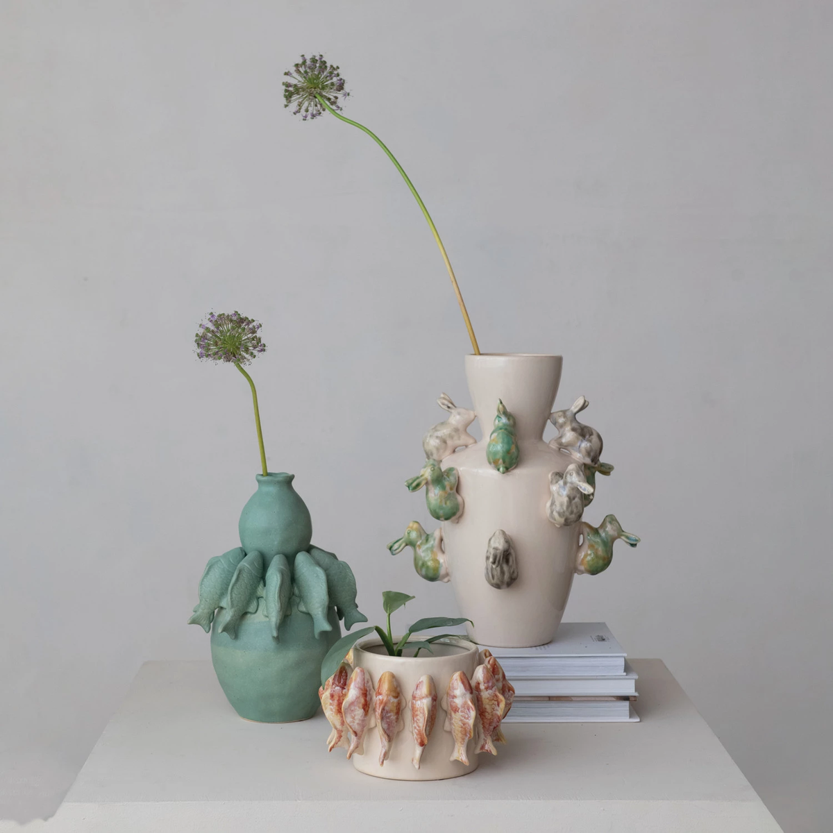 Stoneware vase with reactive glaze featuring a three-dimensional rabbit sculpture on the front.