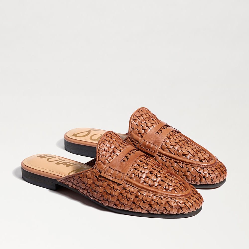 A pair of brown leather Tullie Woven Mules with an almond toe and flat heel.