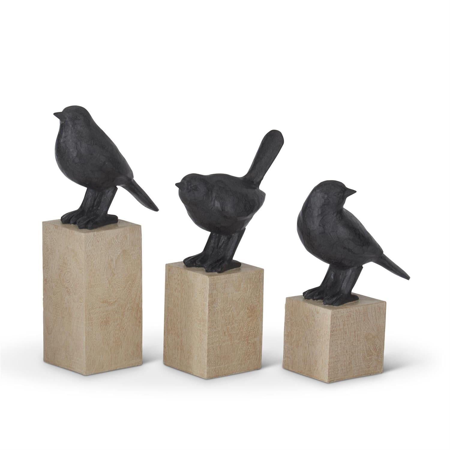 Set of three resin faux cast iron bird figurines perched on light wood block pedestals.