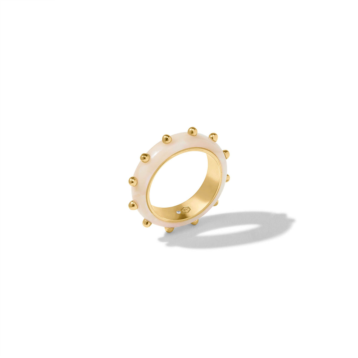 Colette stacking ring featuring a gold-plated acetate band with a smooth silhouette and subtle geometric pattern.