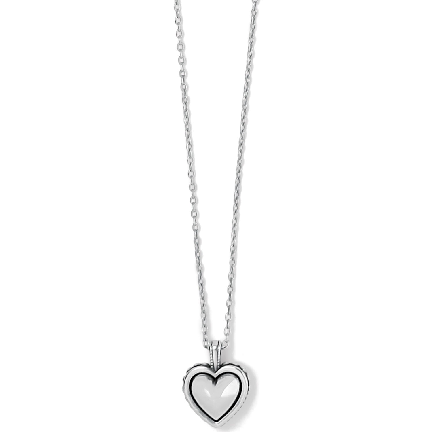 Silver plated petite heart necklace with sculpted studding border on an adjustable chain.