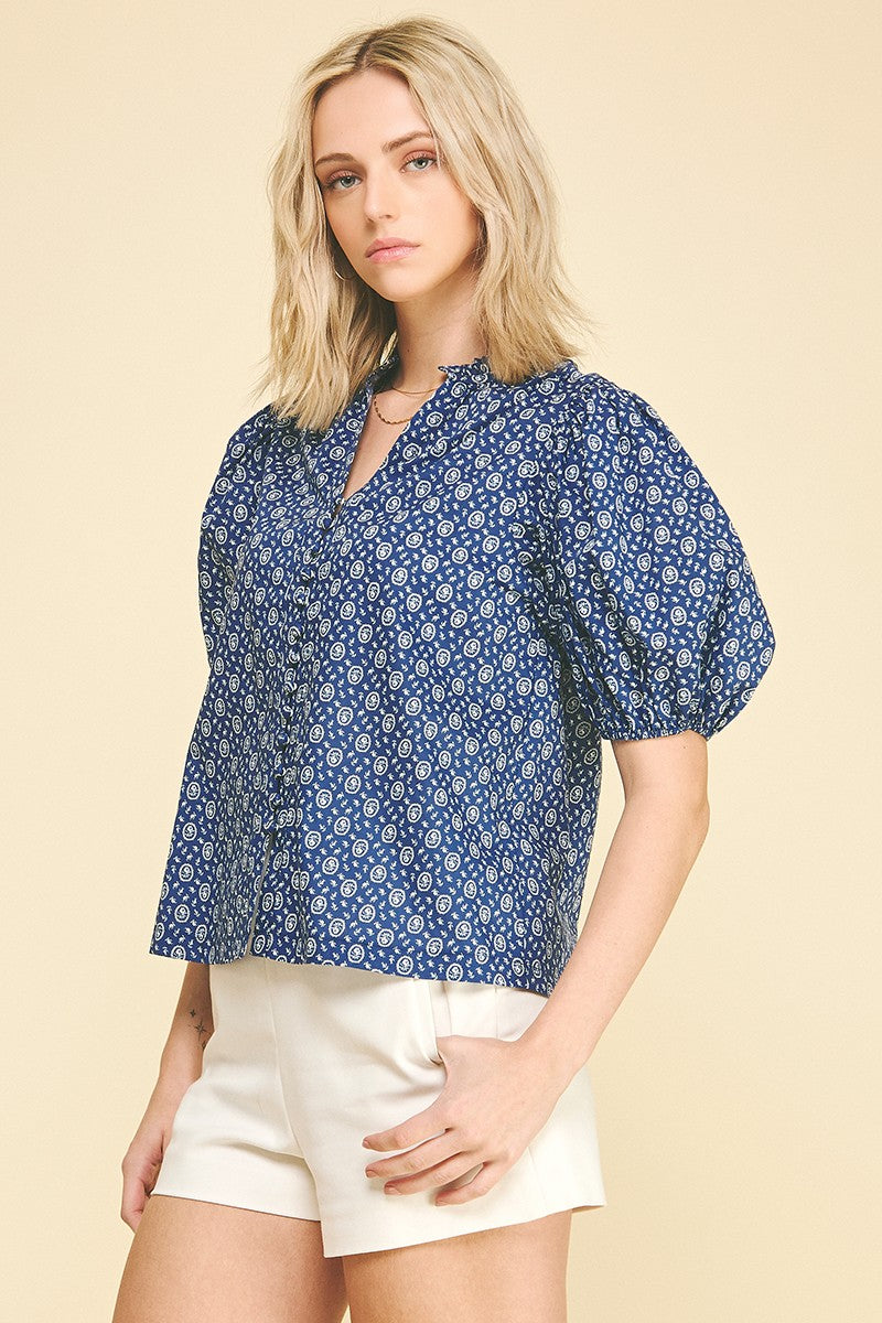 Megan floral print cotton blouse with ruffled V-neck, balloon sleeves, elastic cuffs, and a relaxed silhouette.