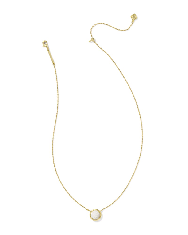 Gold short pendant necklace featuring a circular white mother of pearl volleyball charm.