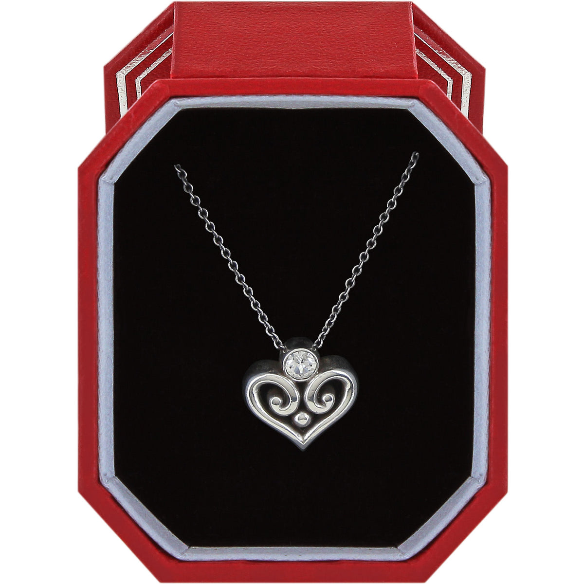 Alcazar silver plated heart necklace with a crystal accent in a red octagonal gift box.