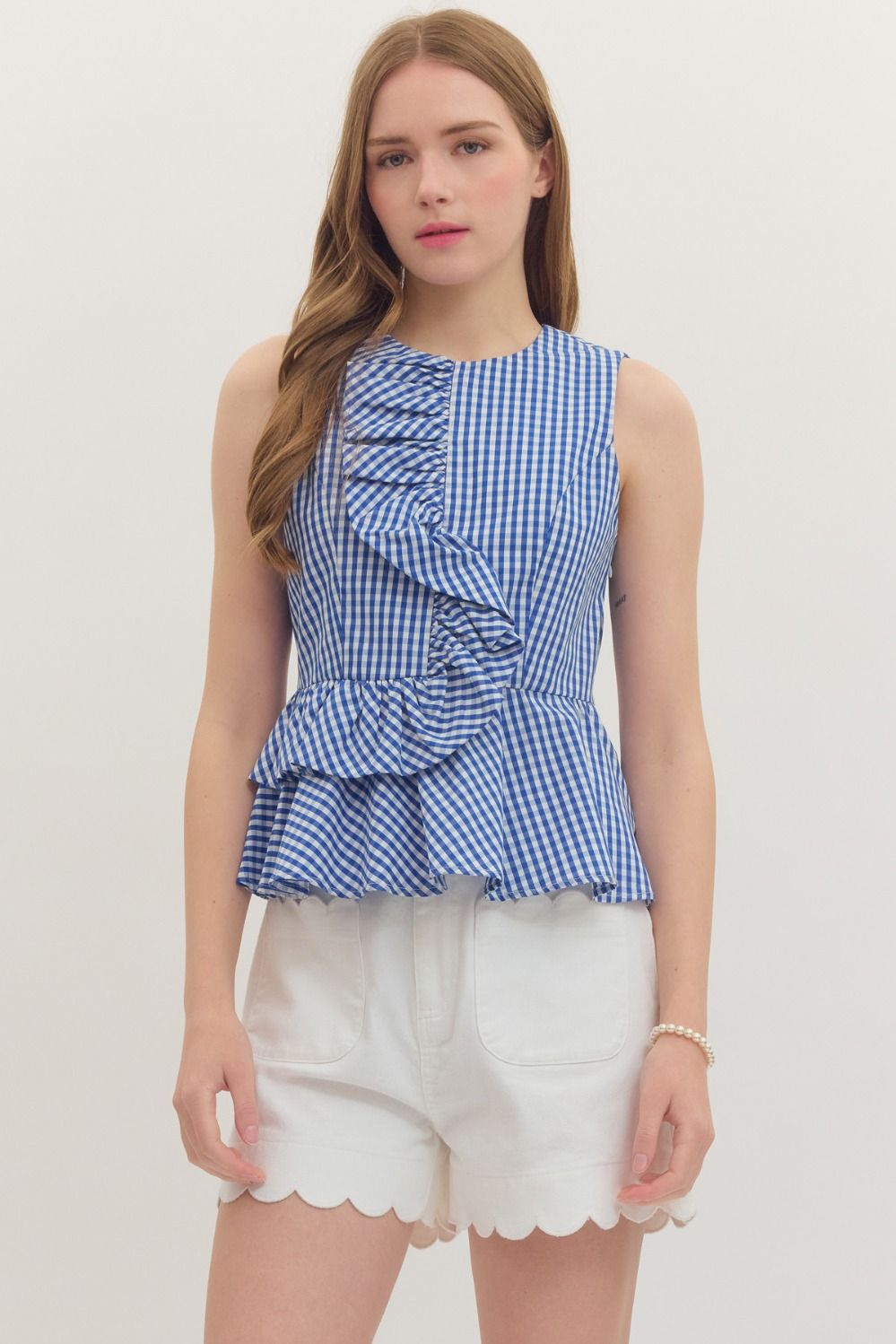 Jessica Gingham sleeveless peplum top in white cotton with asymmetric front ruffle and elasticated back waist.