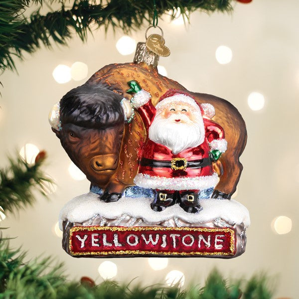Glass Christmas ornament featuring Santa Claus standing next to a bison on a Yellowstone base.