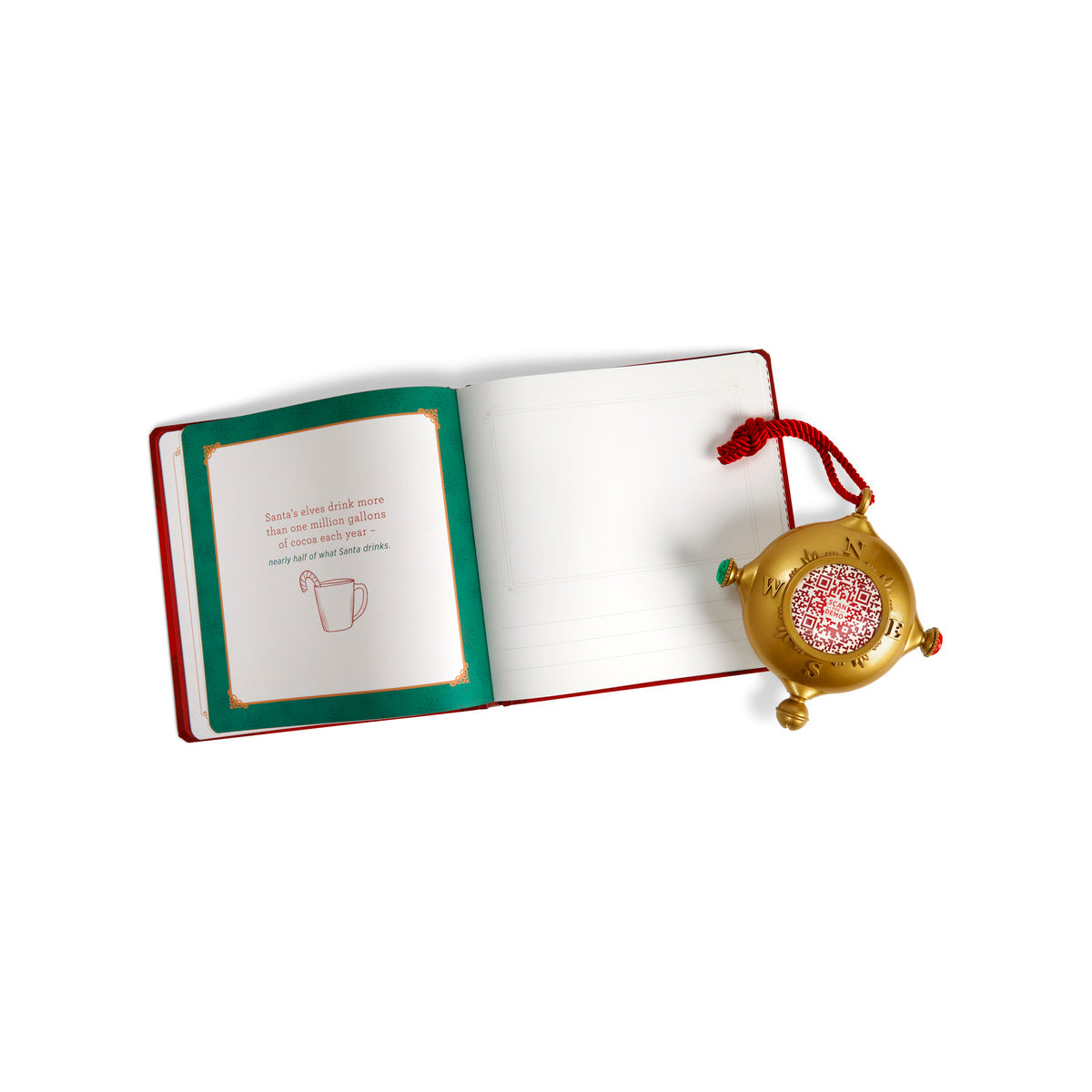 Open red journal with a holiday message next to a gold compass ornament with a red QR code.