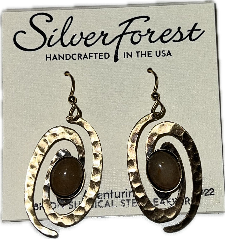 Silver Forest hammered gold-tone coil earrings with oval brown cabochon stones on fish hook backs.