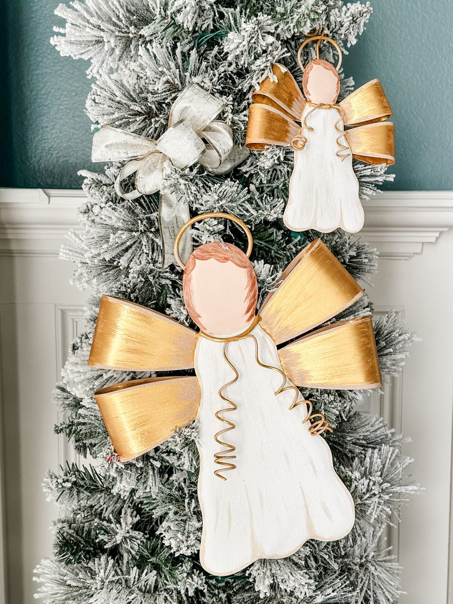 Gilded Ribbon Angel stake ornament with gold ribbon wings and halo on a cream background.