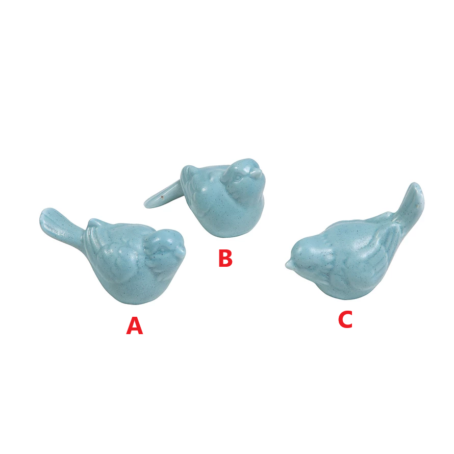 Ceramic bird figurine in aqua glaze with smooth rounded silhouette.