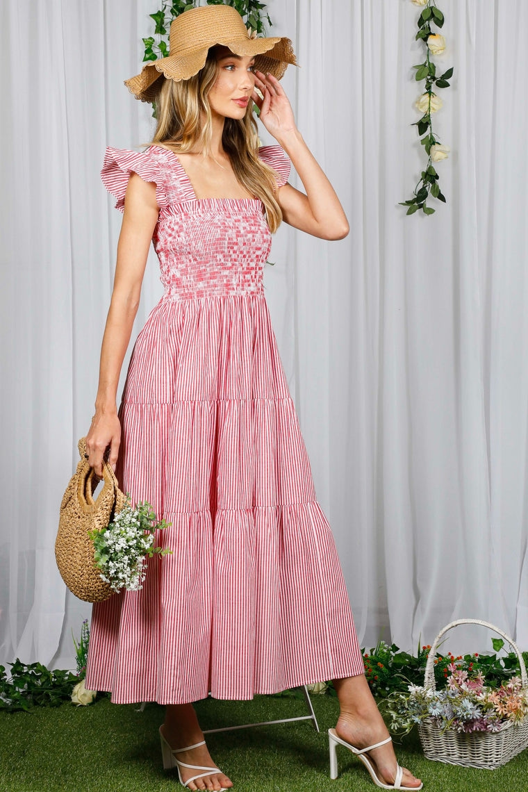 Woman in a red and white striped tiered midi dress with a smocked bust and ruffled straps.